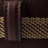 Bolso tipo cubo de piel con hebilla de Prada y cinturón con joyas Bolso tipo cubo de piel con hebilla de Prada y cinturón con joyas
