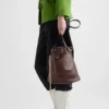 Bolso tipo cubo de piel con hebilla de Prada y cinturón con joyas Bolso tipo cubo de piel con hebilla de Prada y cinturón con joyas