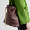 Bolso tipo cubo de piel con hebilla de Prada y cinturón con joyas Bolso tipo cubo de piel con hebilla de Prada y cinturón con joyas