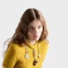 Jersey de punto de lana de manga corta con colgantes Jersey de punto de lana de manga corta con colgantes